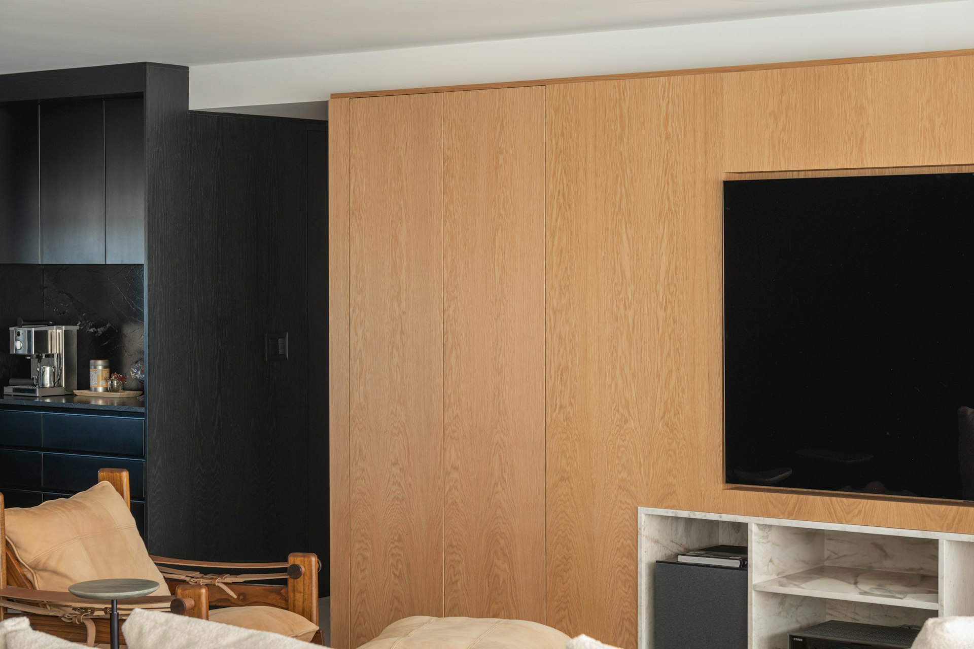 Modern living room with wood paneling and television